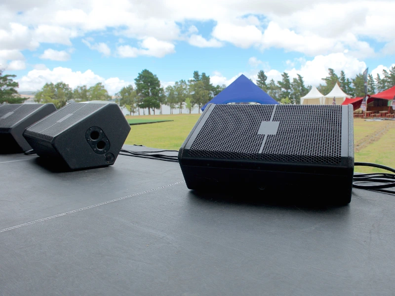 A Guide to Stage Monitor Speakers - Foldback Monitors at the front of a Stage